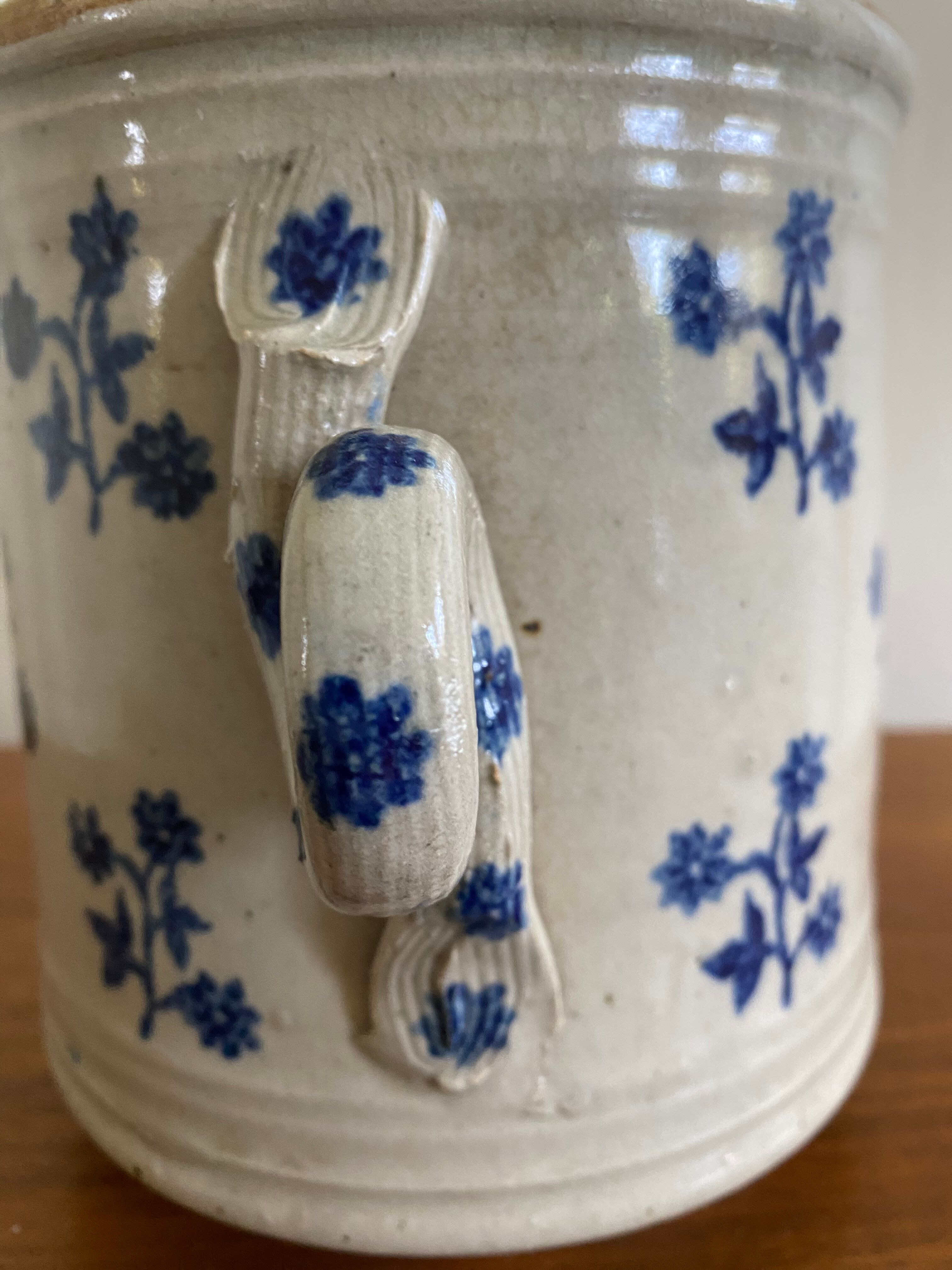 Old pot, sandstone, blue flower decoration