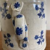 Old pot, sandstone, blue flower decoration