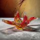 Vintage Murano glass bowl/plate in orange-red with swirling patterns.