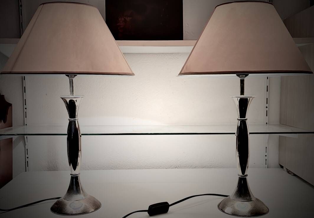 Contemporary table lamp in polished chrome with a conical fabric shade.