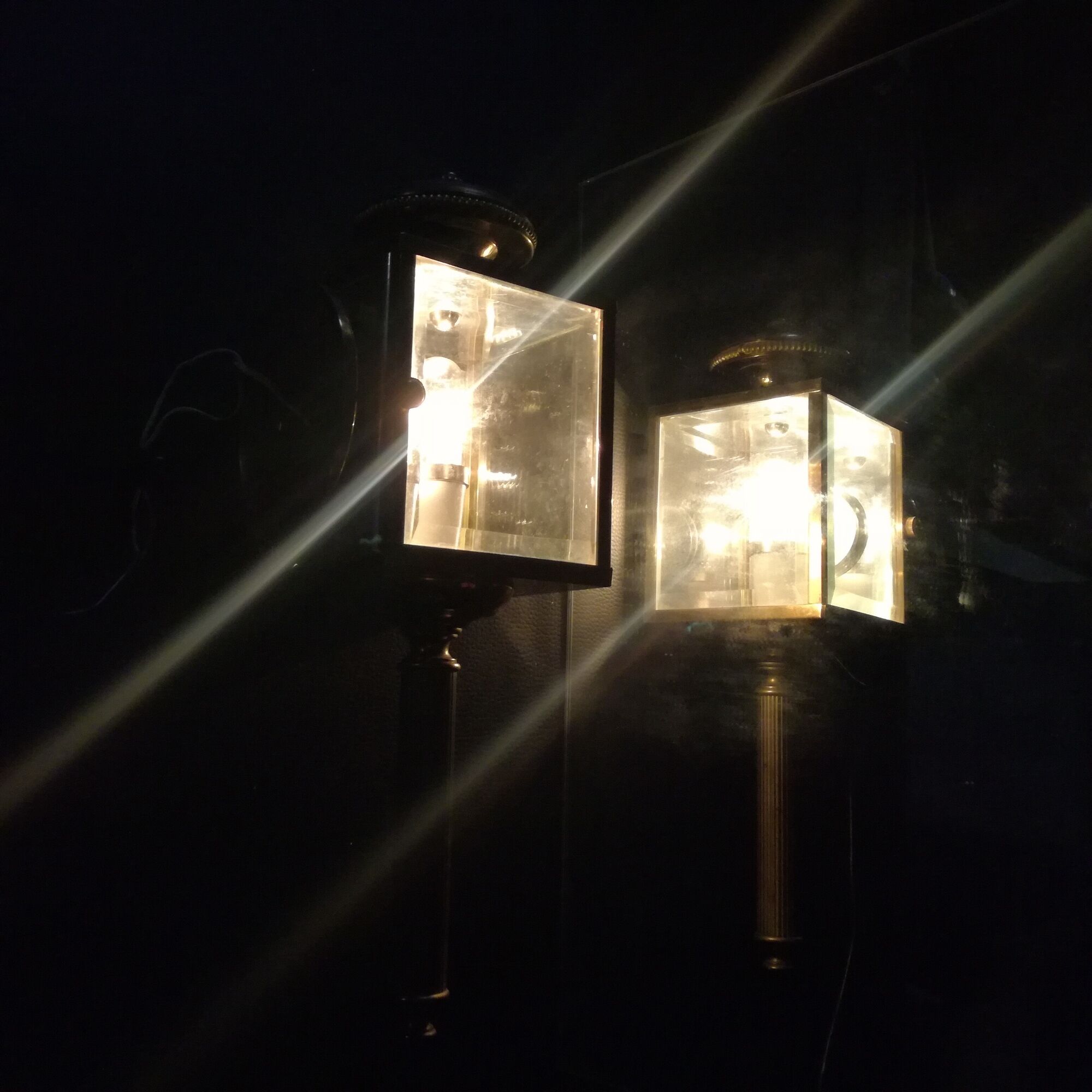 Brass and beveled glass lantern-like wall lamps in brass and beveled glass