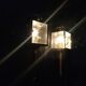 Brass and beveled glass lantern-like wall lamps in brass and beveled glass