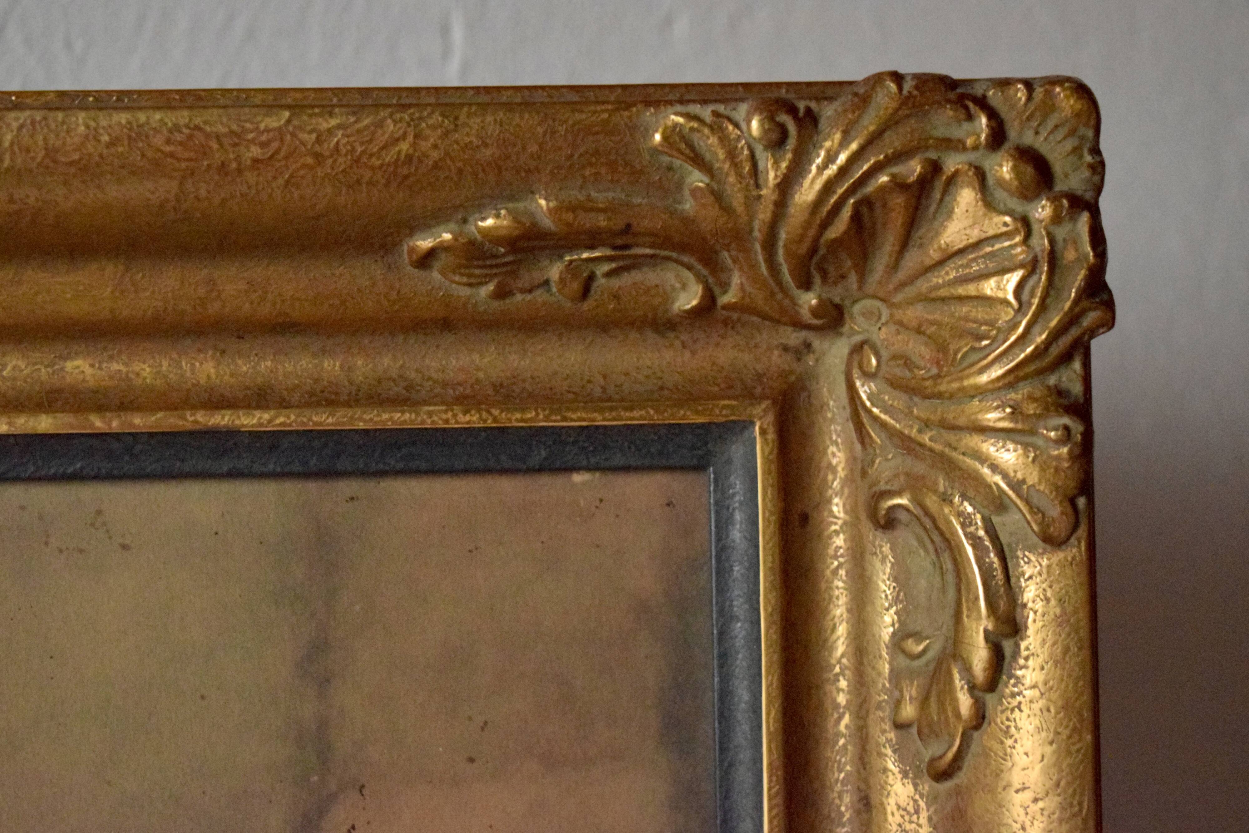Old large wall frame in gilded carved wood