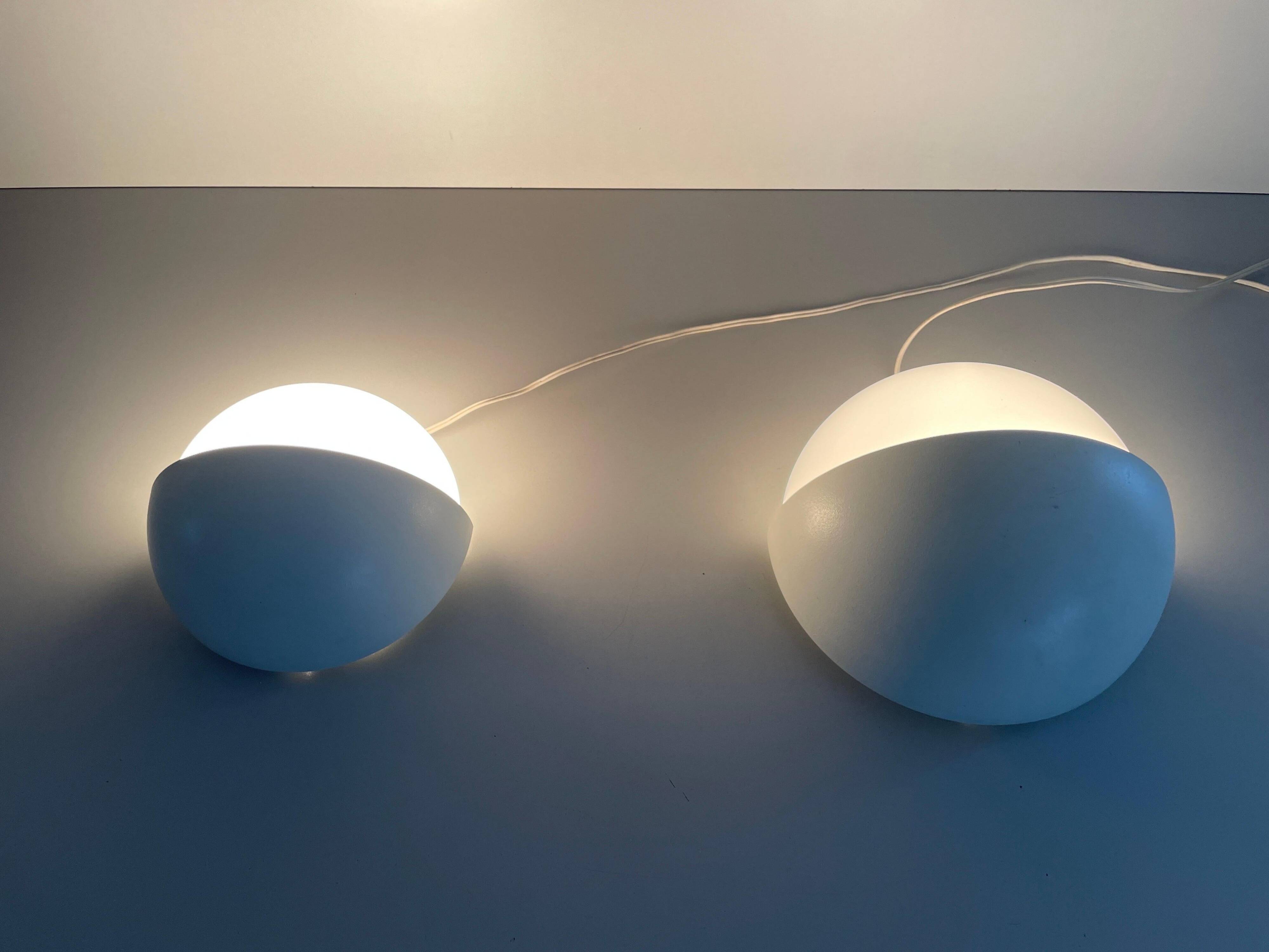 Round wall lights, small and large, in white metal by Bega, 1970s, Germany.