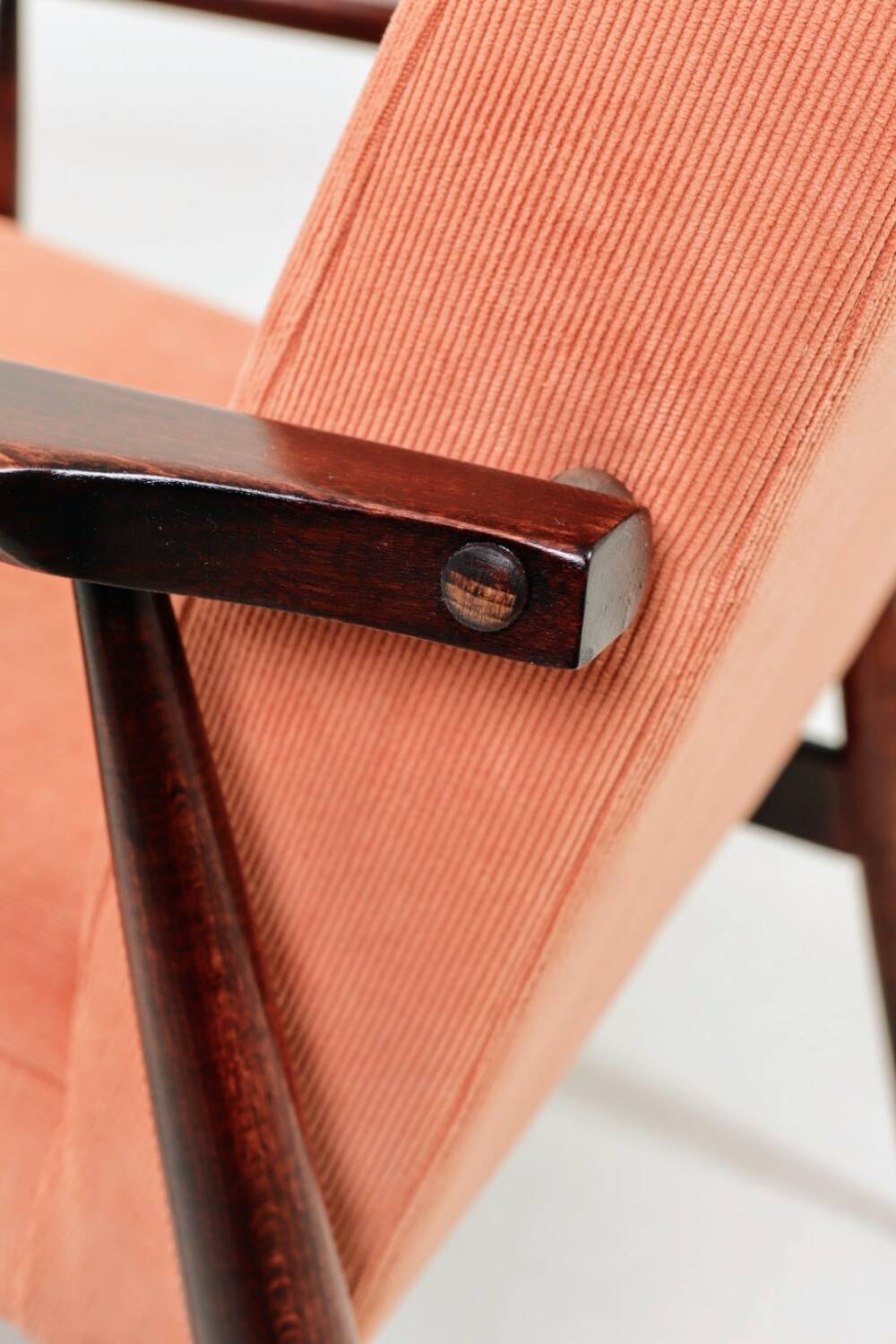 Mid-century modern armchair in coral red designed by H. Lis.