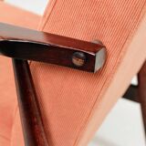 Mid-century modern armchair in coral red designed by H. Lis.