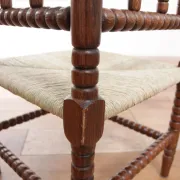 Antique Dutch oak corner chair with turned spindles and new rush seat