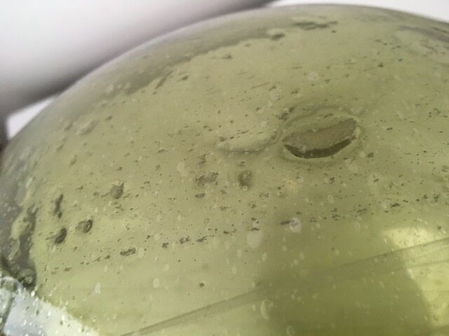 Old demijohn full of bubbles