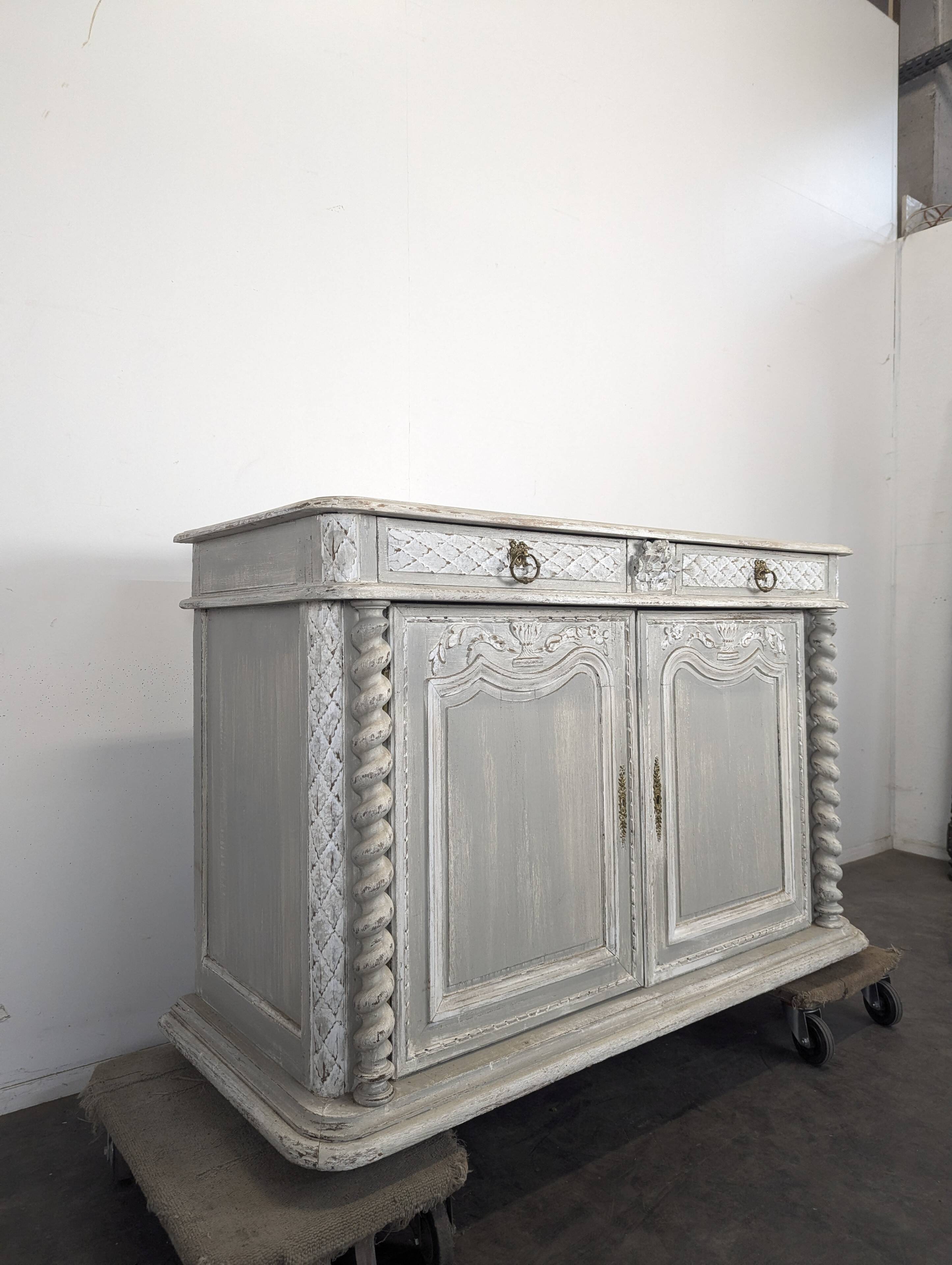 Louis XIII buffet with twisted column in grey patinated oak, two doors, two drawers.