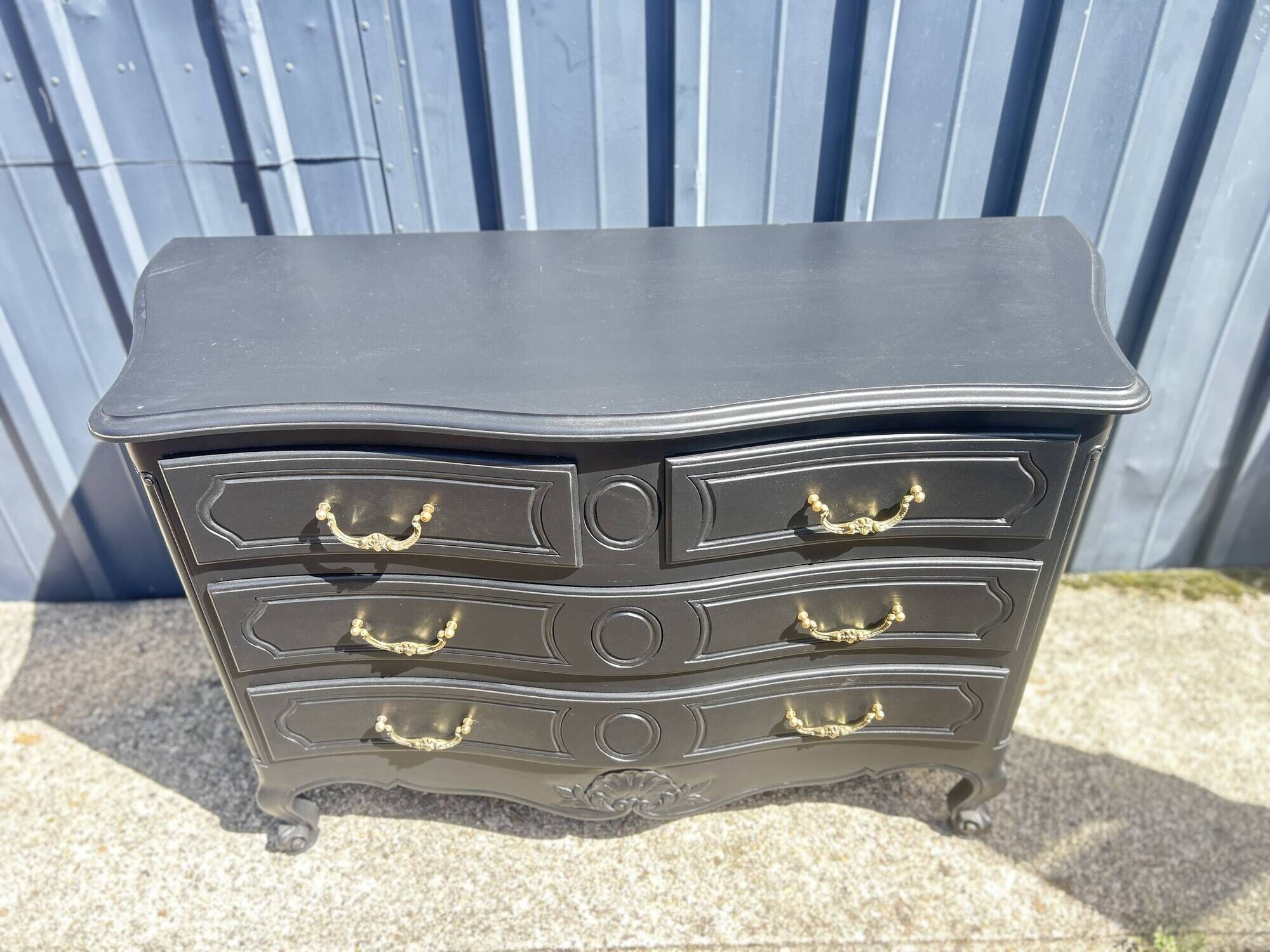 Louis XV style black lacquered chest of drawers with four drawers.