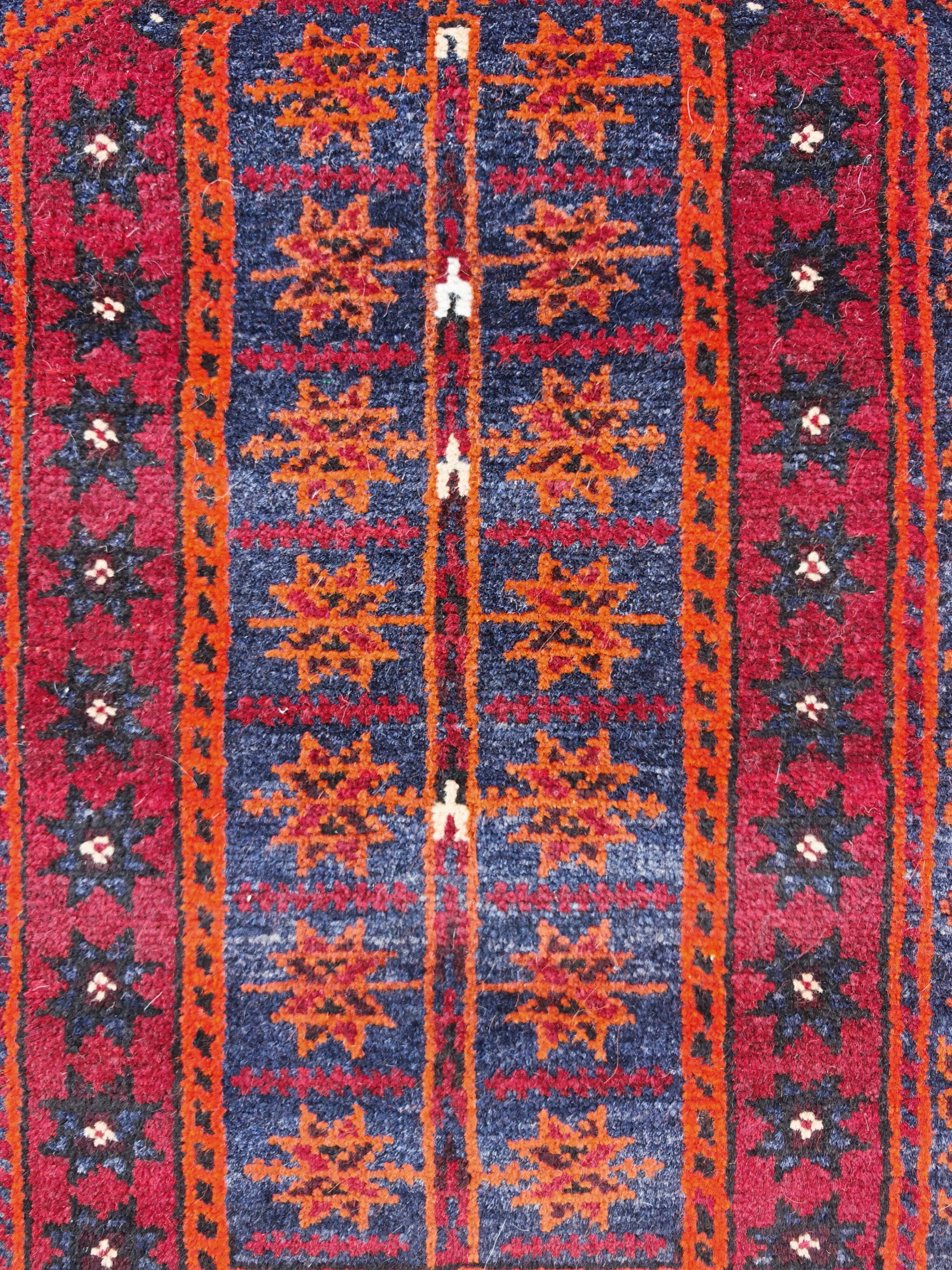 Vintage hand-knotted Persian Baluch prayer rug from the 1940s.
