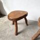 Set of three rustic solid wood tripod stools.