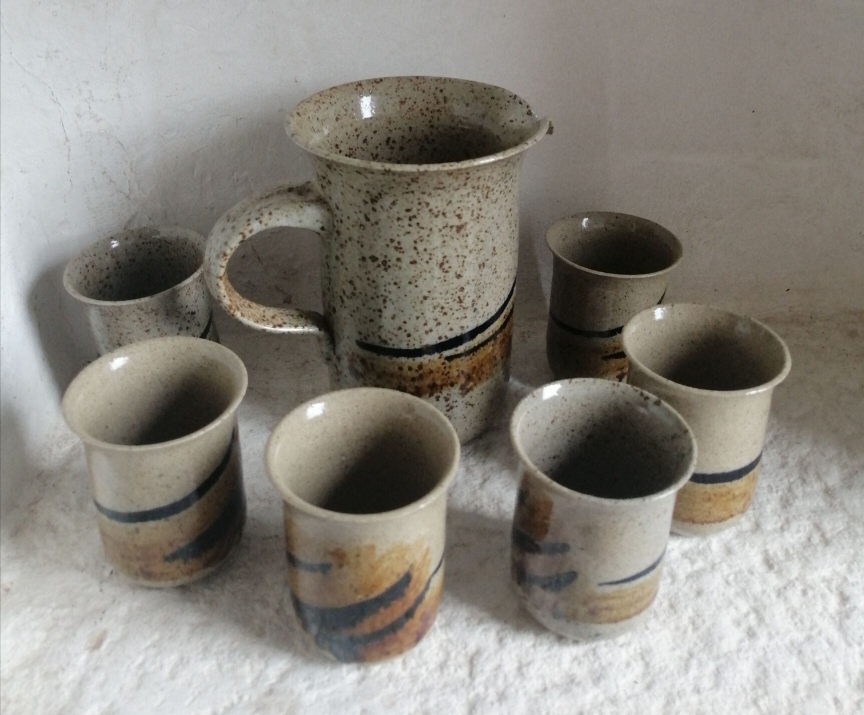 Enamelled sandstone pitcher and glasses