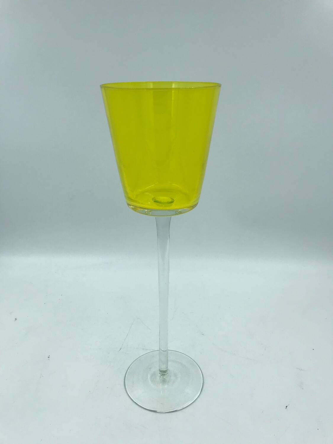Yellow glass candlestick on a stand