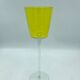 Yellow glass candlestick on a stand