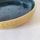 Blue floral glazed stoneware plate with a yellow rim.