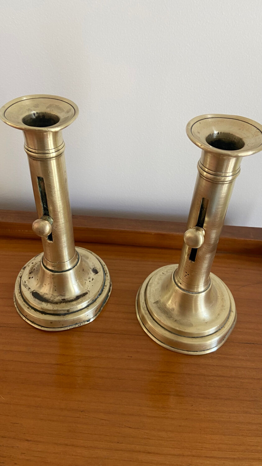 Pair of antique brass push candlesticks