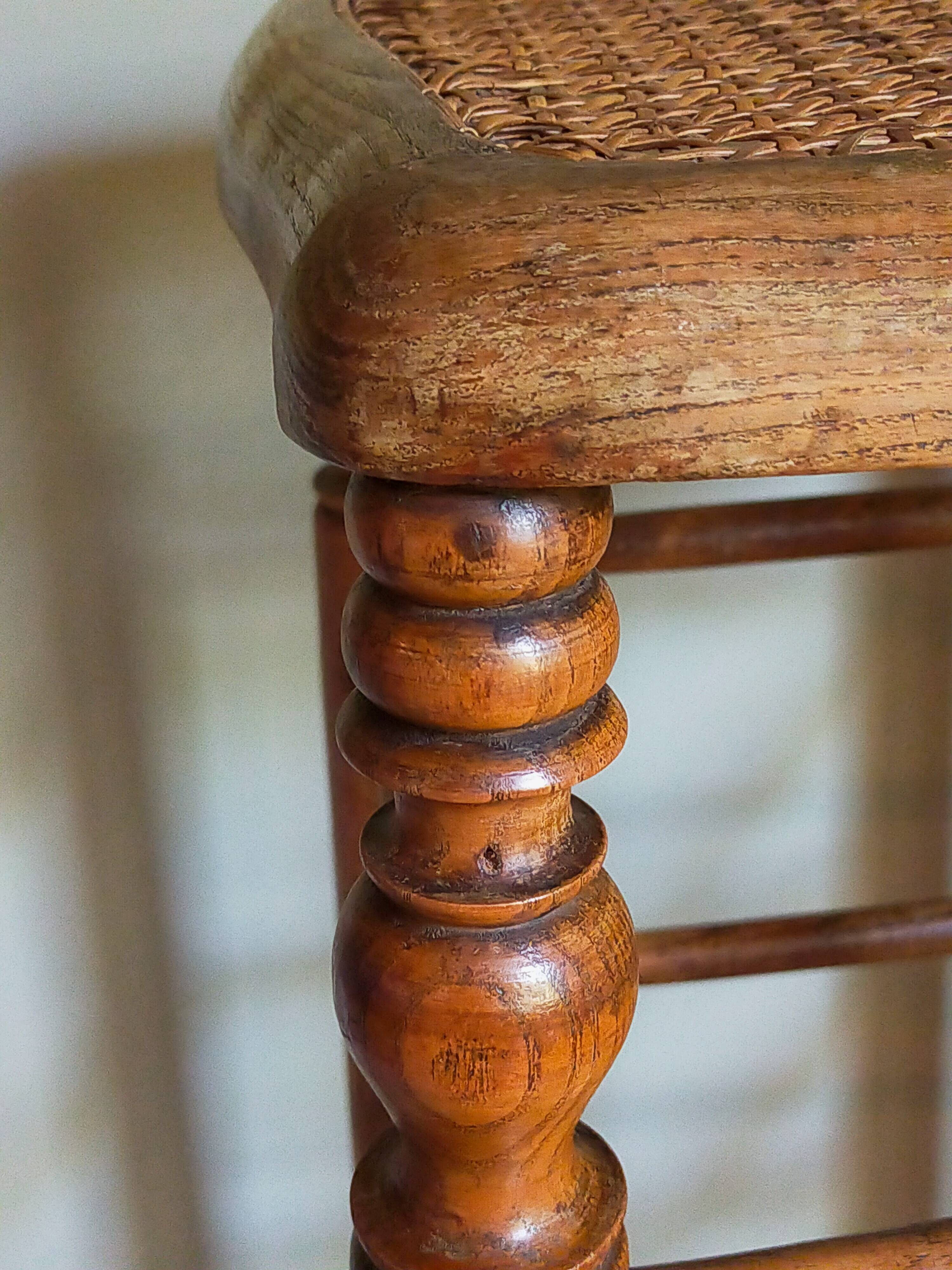 Antique stool with cane and turned wood