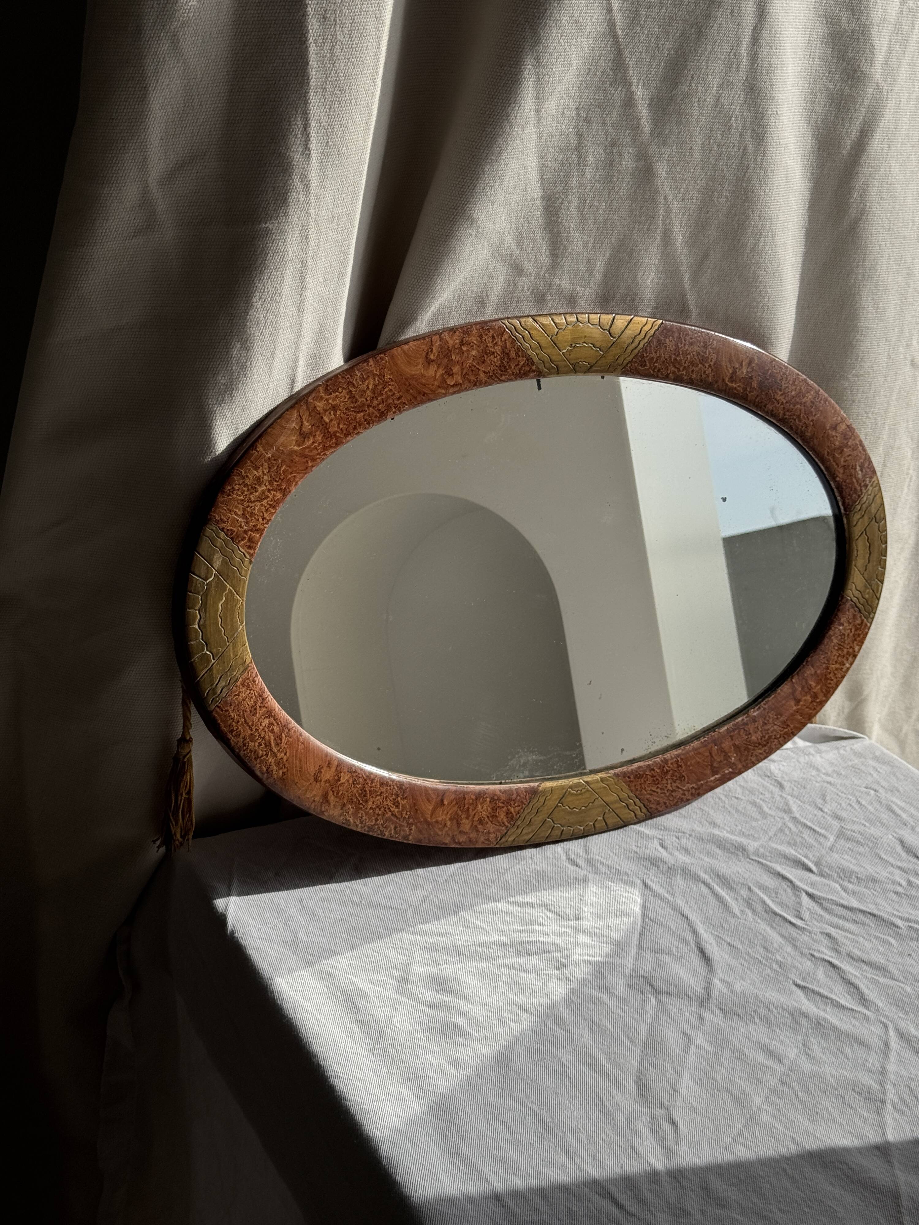 Small oval Art Deco mirror in brown and gold 33x54.