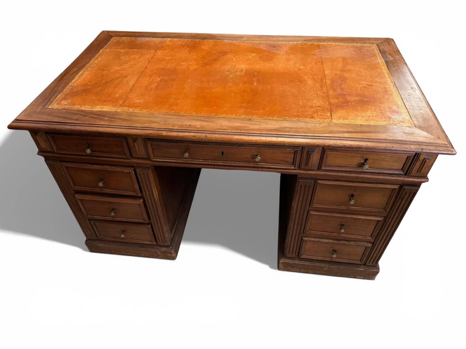 Oak desk with 9 drawers and leather writing pad.