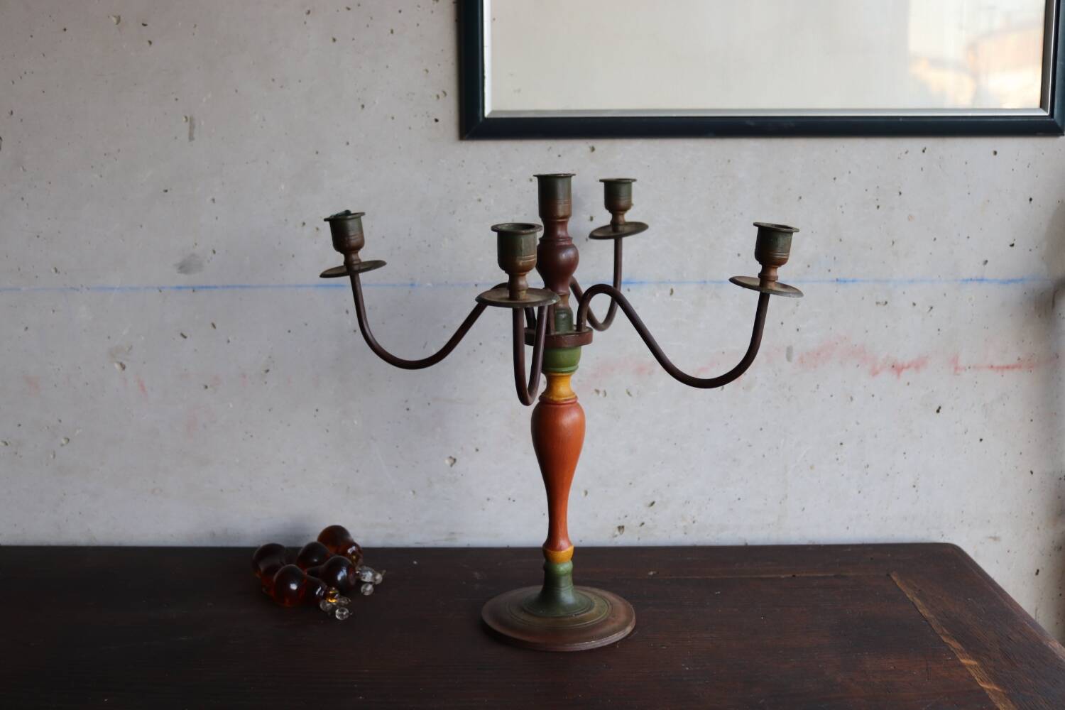 Old candlestick in painted wood and folding metal