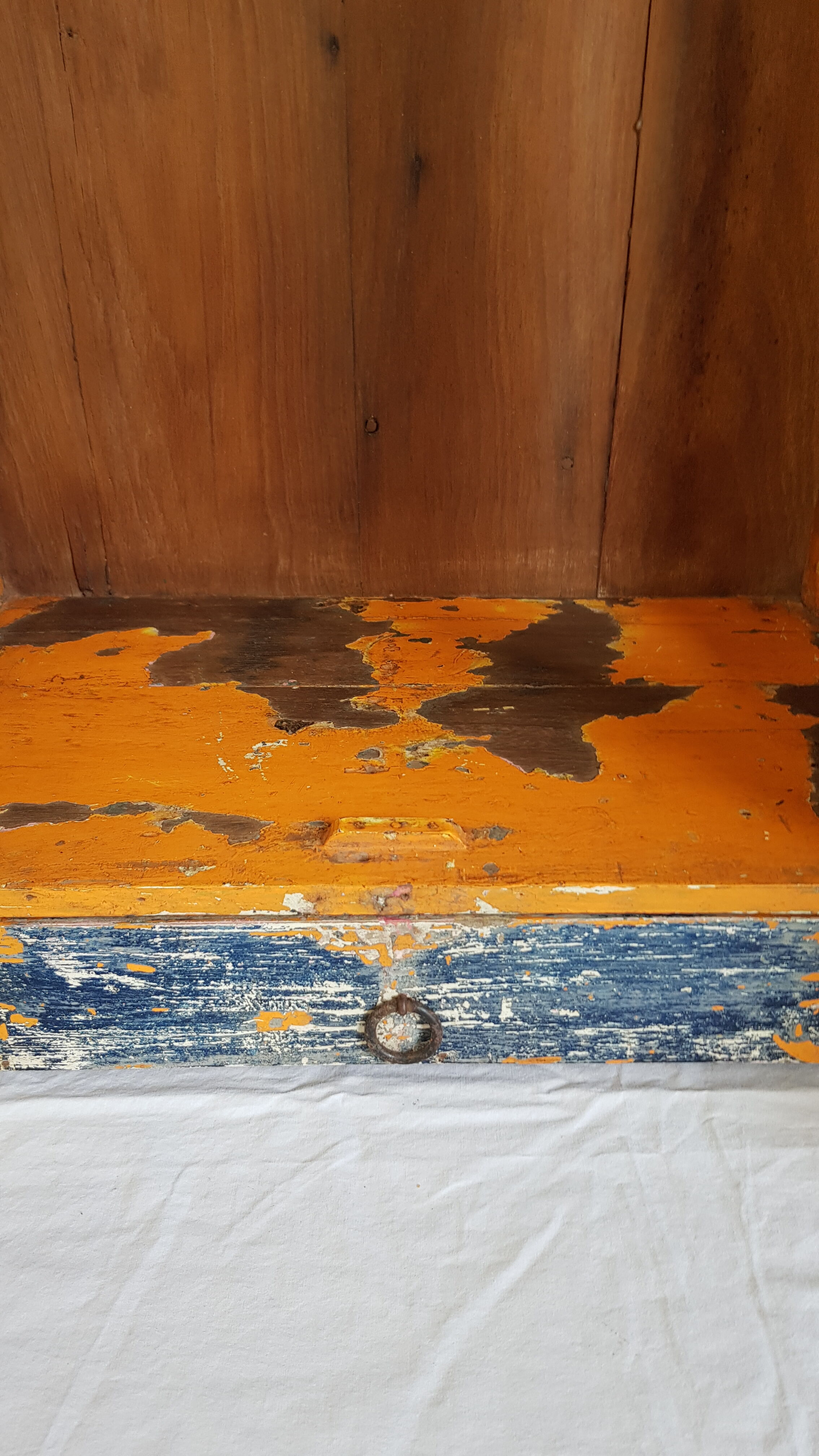 Old temple-showcase with teak offerings