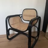 Black armchair with cane and natural rattan