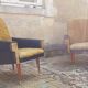 Pair of vintage 60s armchairs in black imitation leather and mustard toffee