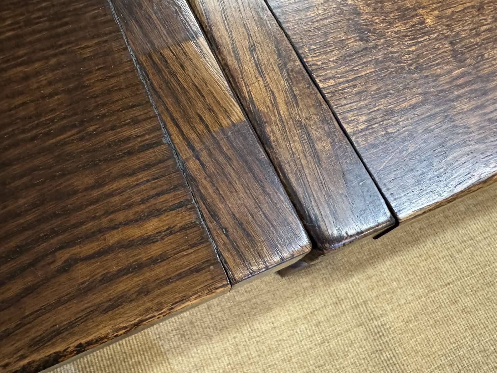 English monastery table with extensions from the late 19th century in elm and oak.