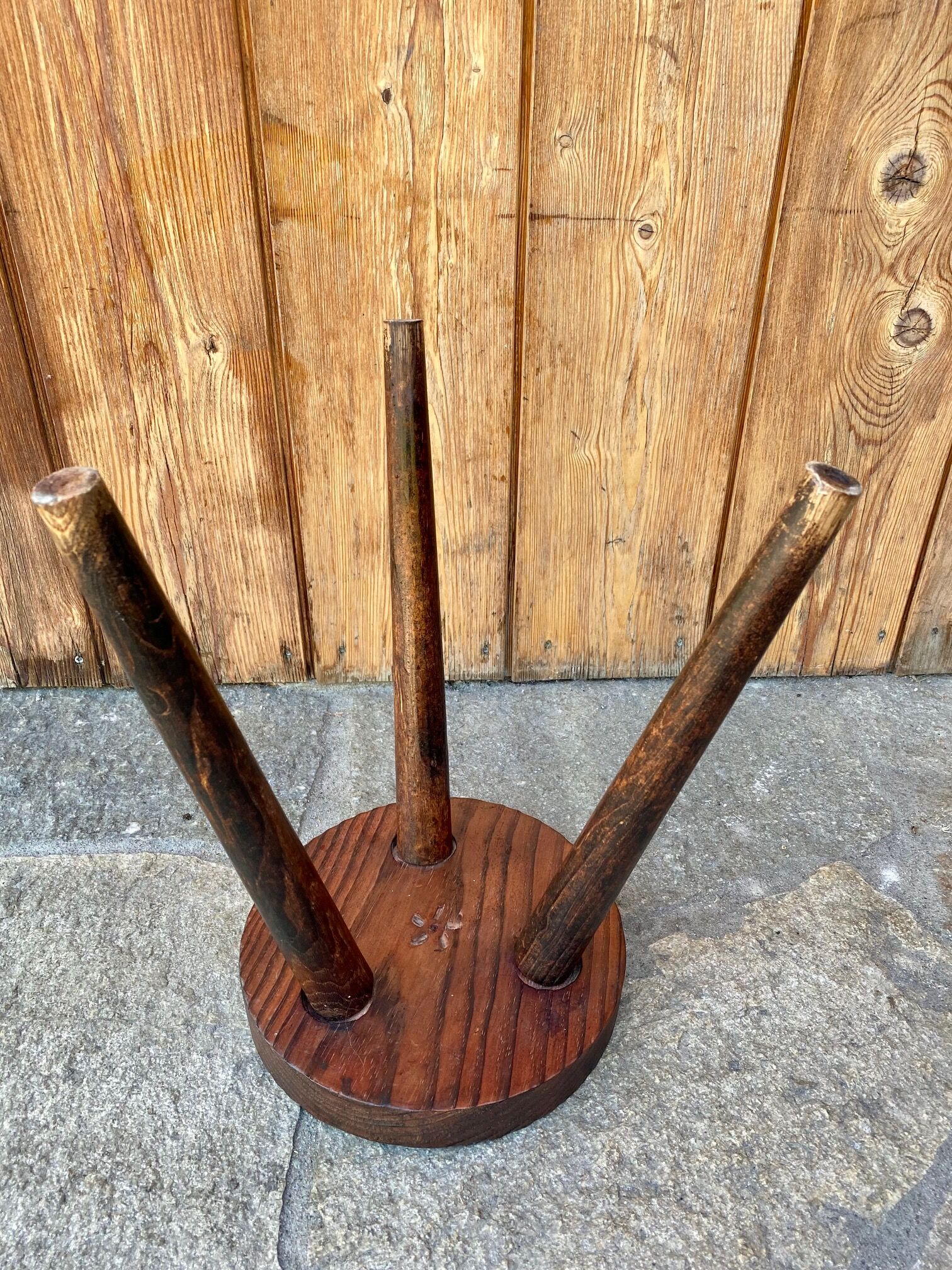 Wooden tripod stool.