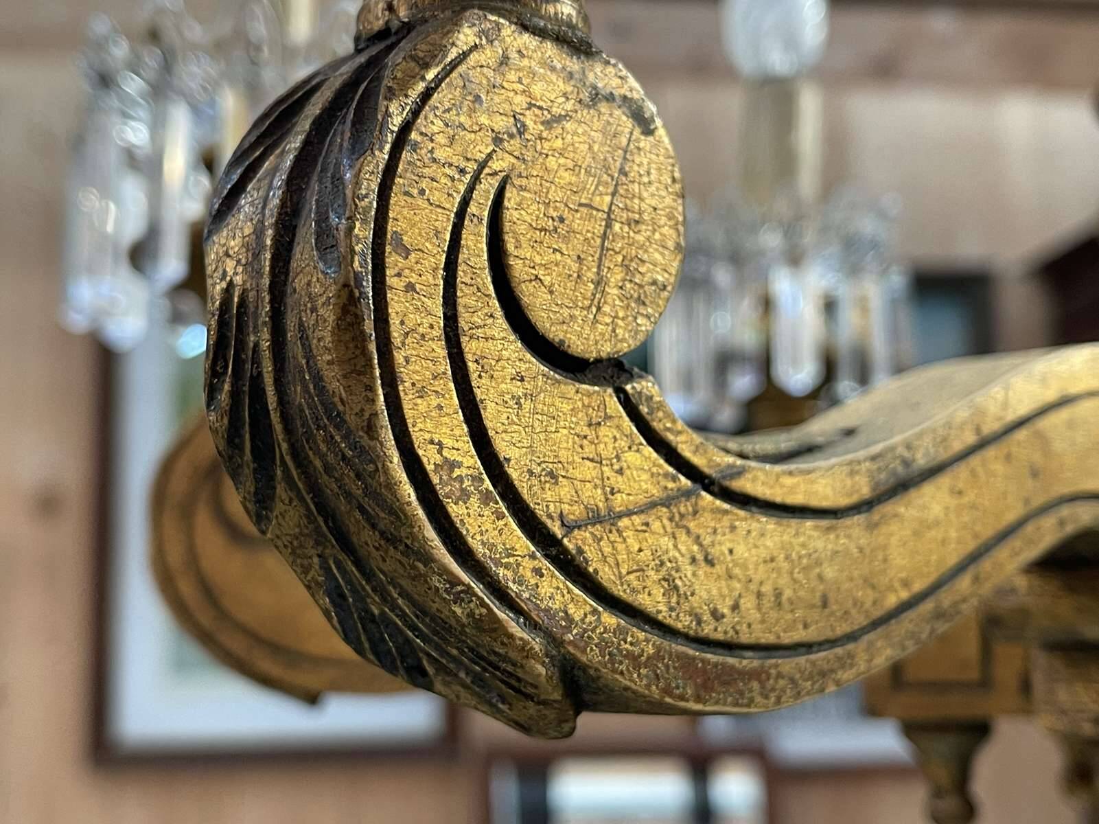 Golden wooden chandelier with crystal pendants from the 19th century.