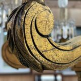 Golden wooden chandelier with crystal pendants from the 19th century.