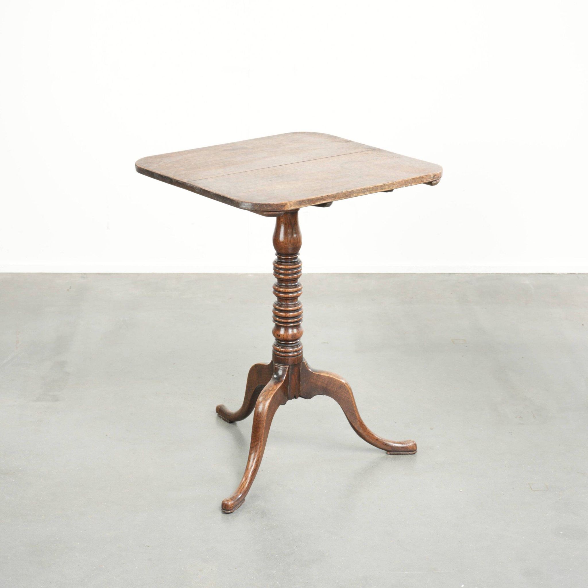 Antique English oak tilt top table from the 19th century in a unique shape