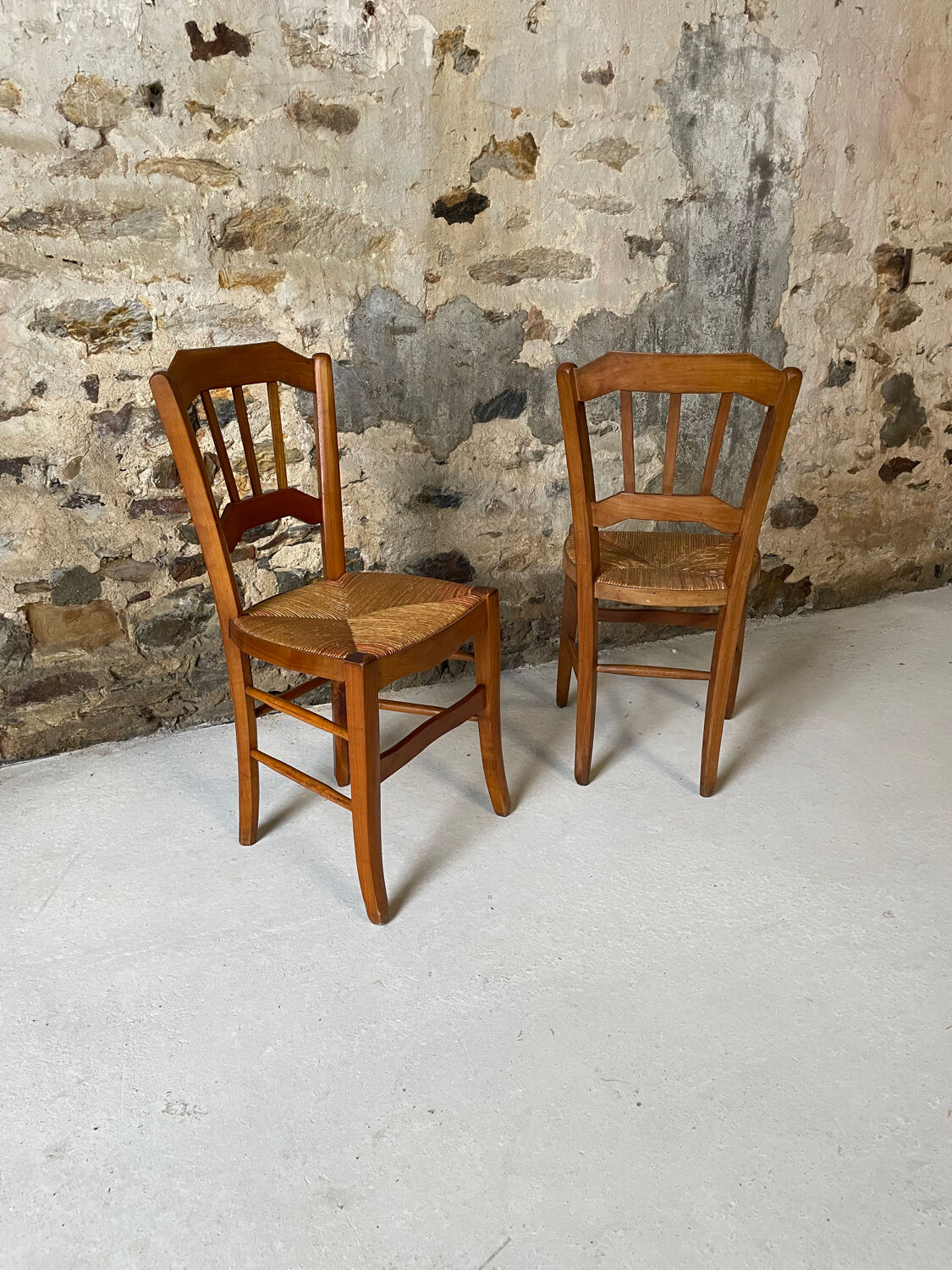 Set of 2 antique wooden and straw chairs.