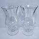 Pair of tall clear glass candlesticks from the early 20th century
