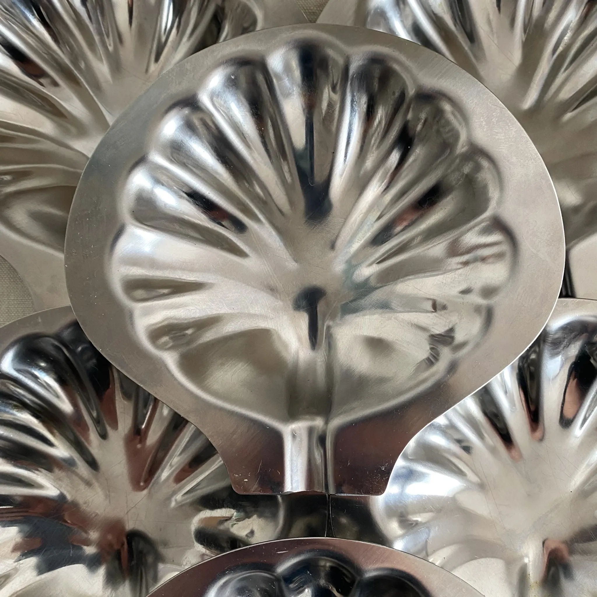 Set of 12 stainless steel scallop shells, 1970s-80s.