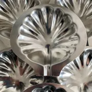 Set of 12 stainless steel scallop shells, 1970s-80s.