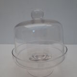 Old bell with cakes on glass stand