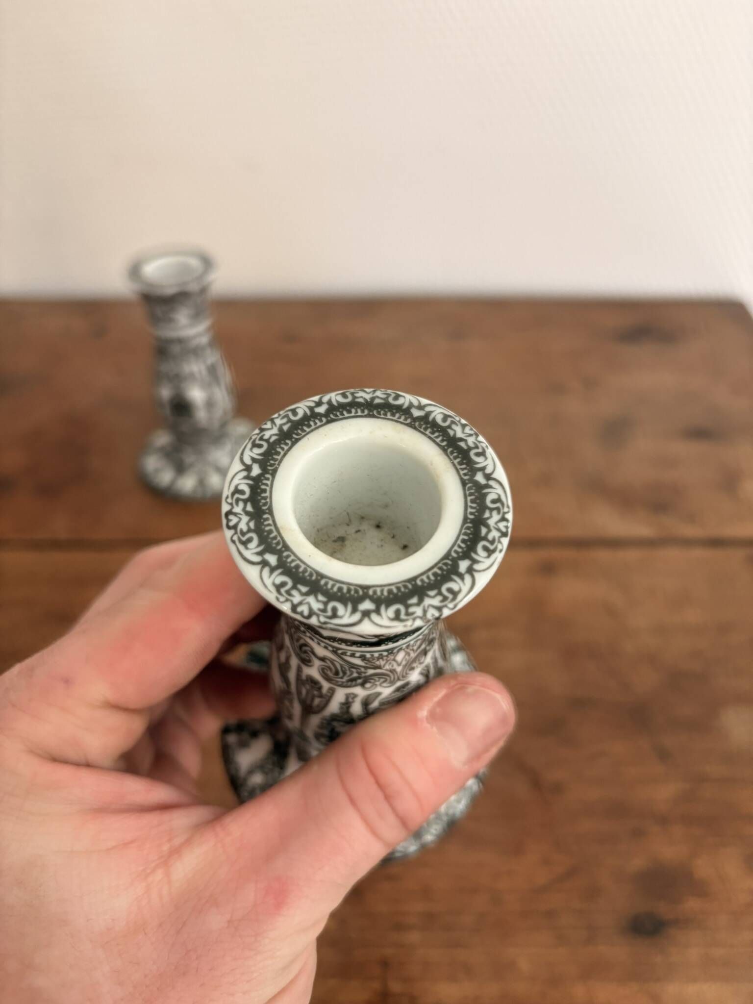 Pair of White and Black Porcelain Candle Holders with Berain Scroll Decoration, Baluster Style