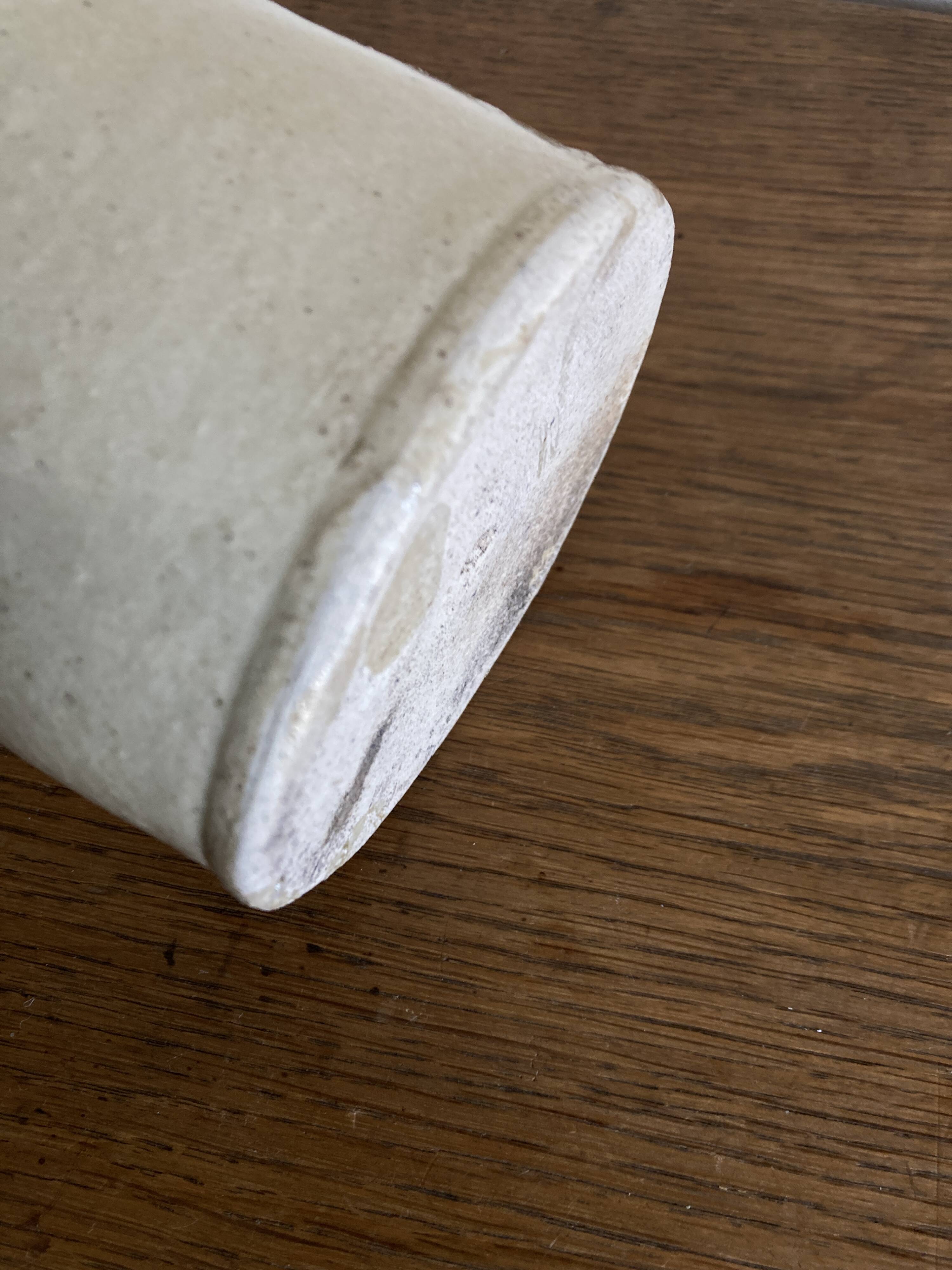 Stoneware bottle tilted at an angle, early 20th century