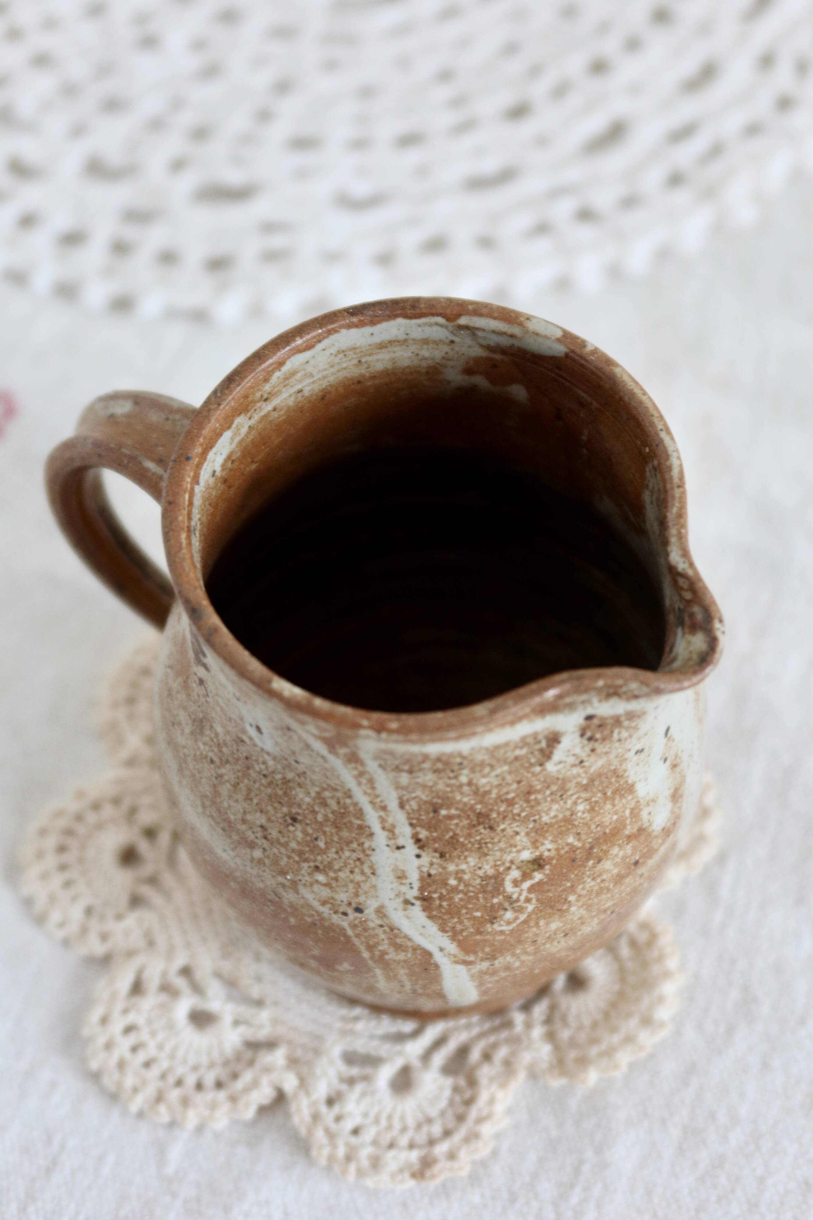 Small vintage hand turned ceramic milk jug with rustic glaze