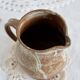 Small vintage hand turned ceramic milk jug with rustic glaze