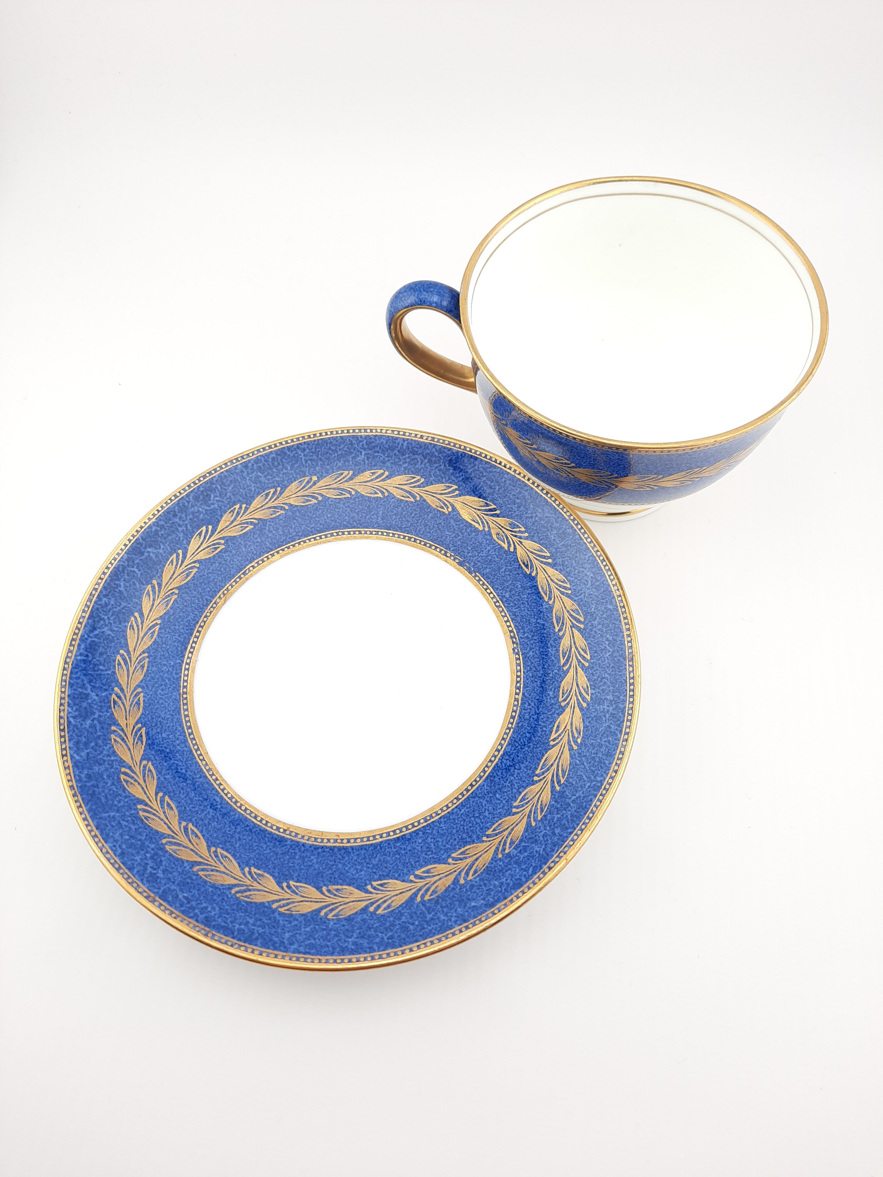 Antique Wedgwood teacup and saucer, bone china. Powder blue and gold English footed cup and saucer,