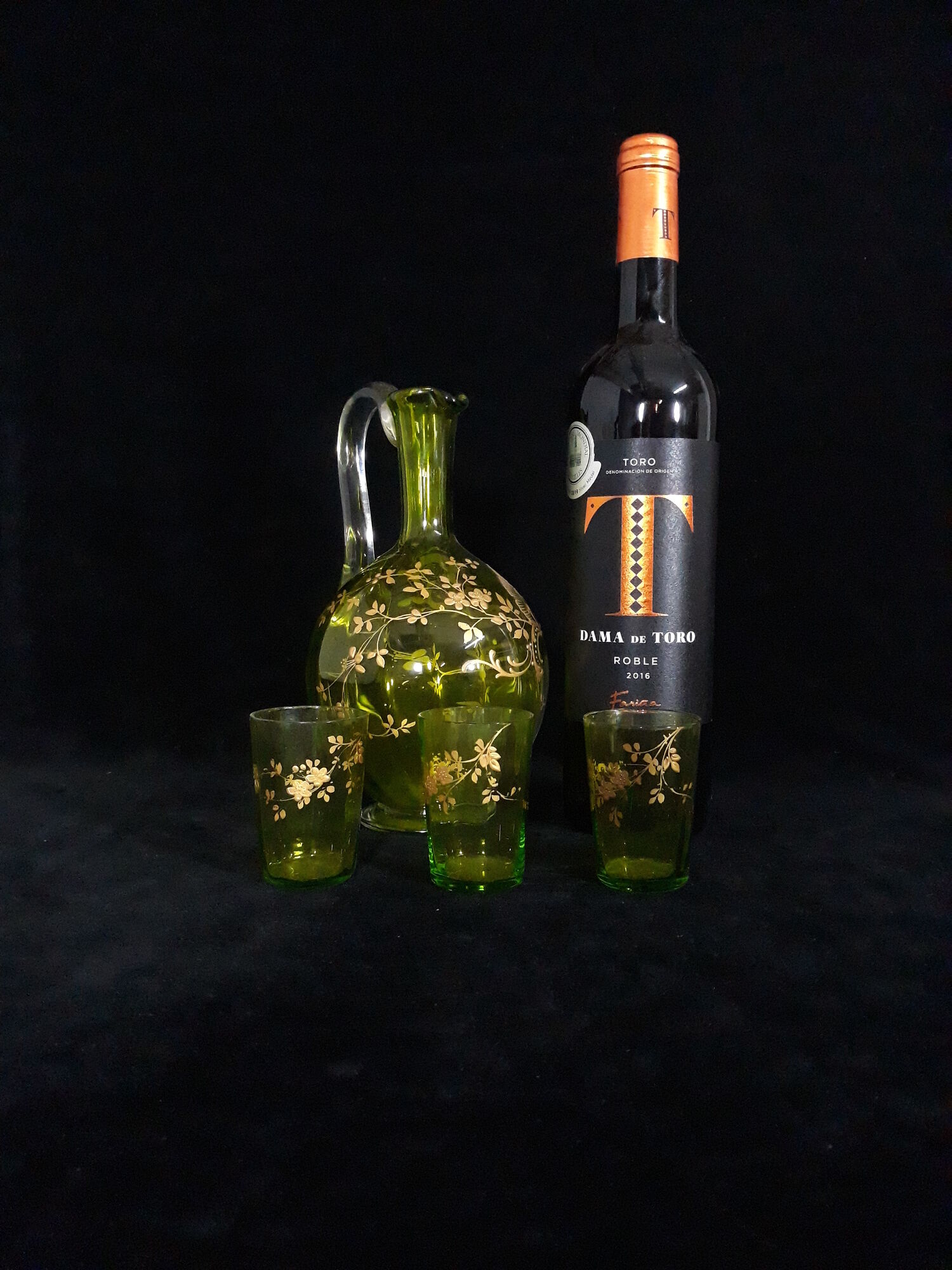 Small carafe and green glass drop glasses with rococo golden emailed decor