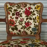 Convertible armchair with brocade fabric and floral patterns.