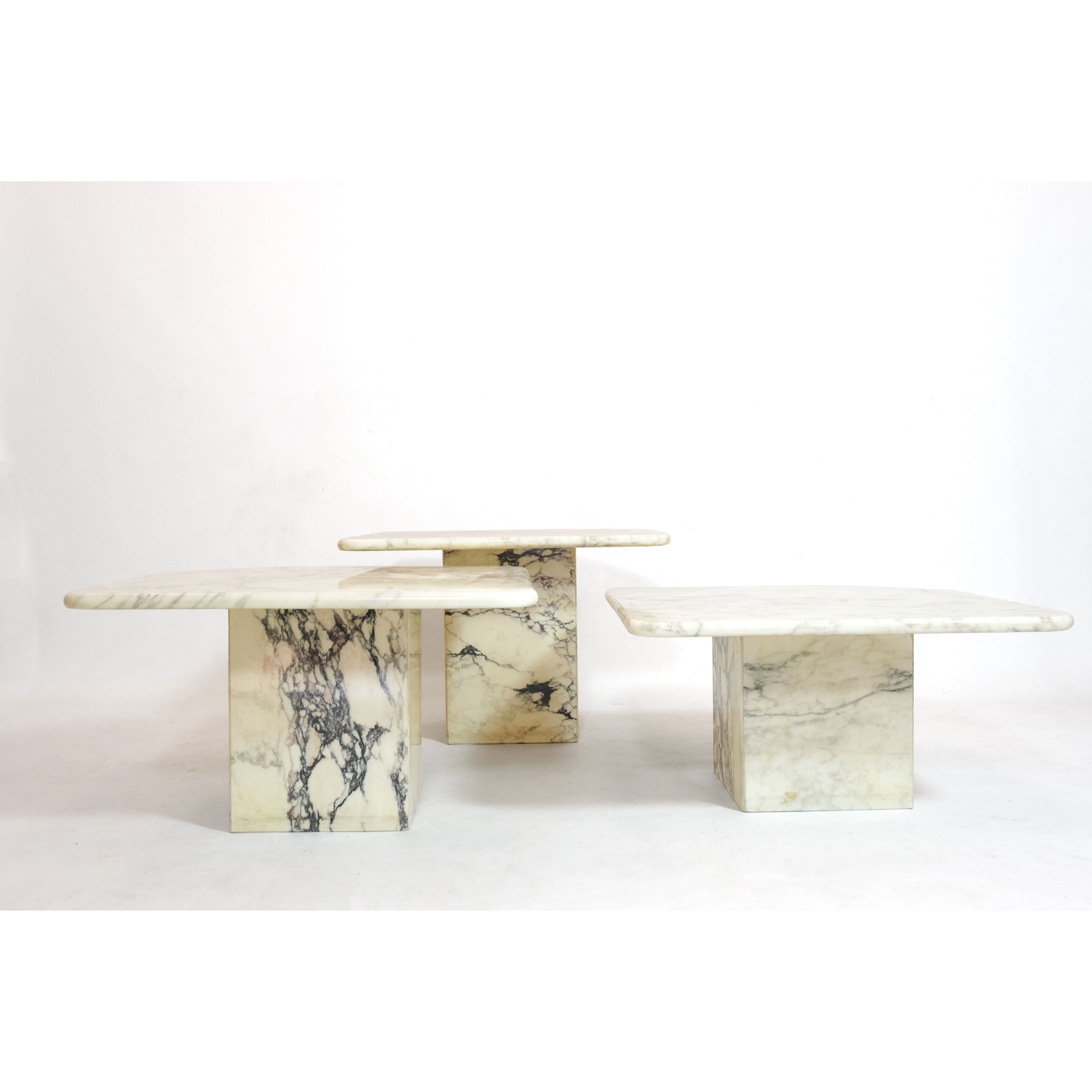 Suite of three marble trundle tables, 1970s