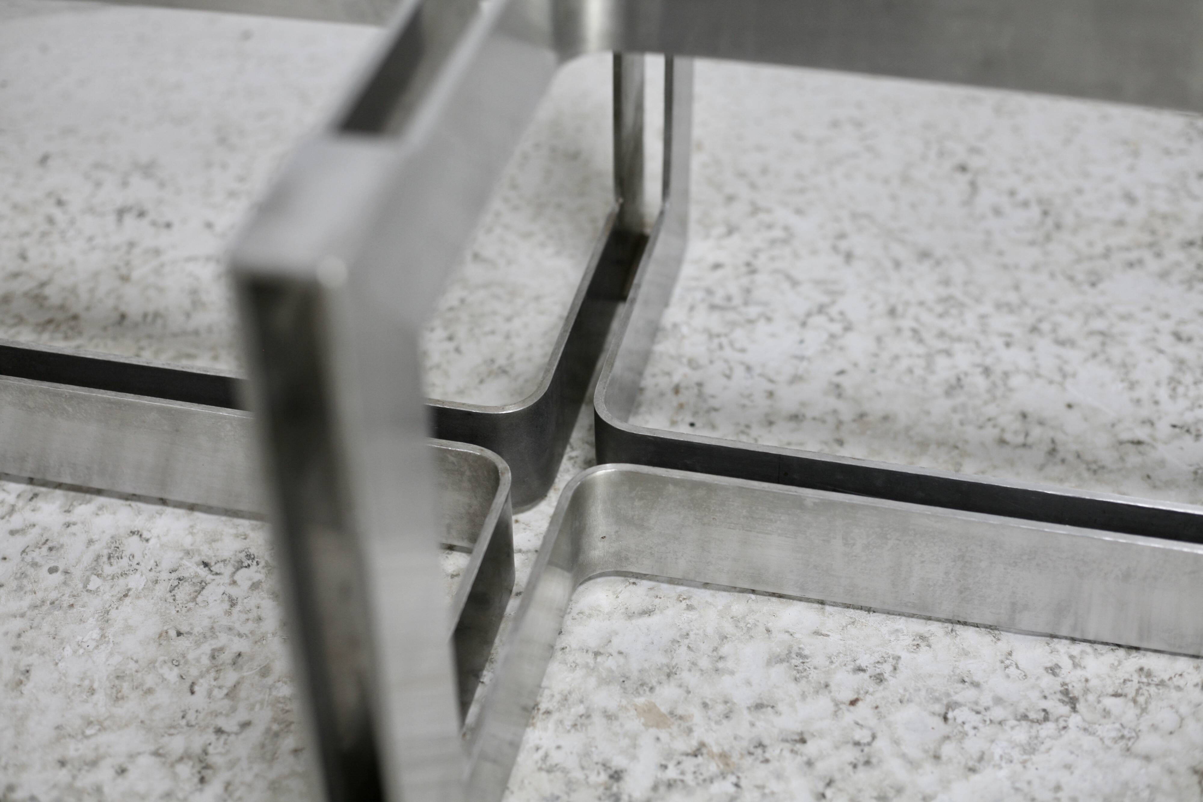 Coffee table with steel base and smoked glass slab. Circa 197