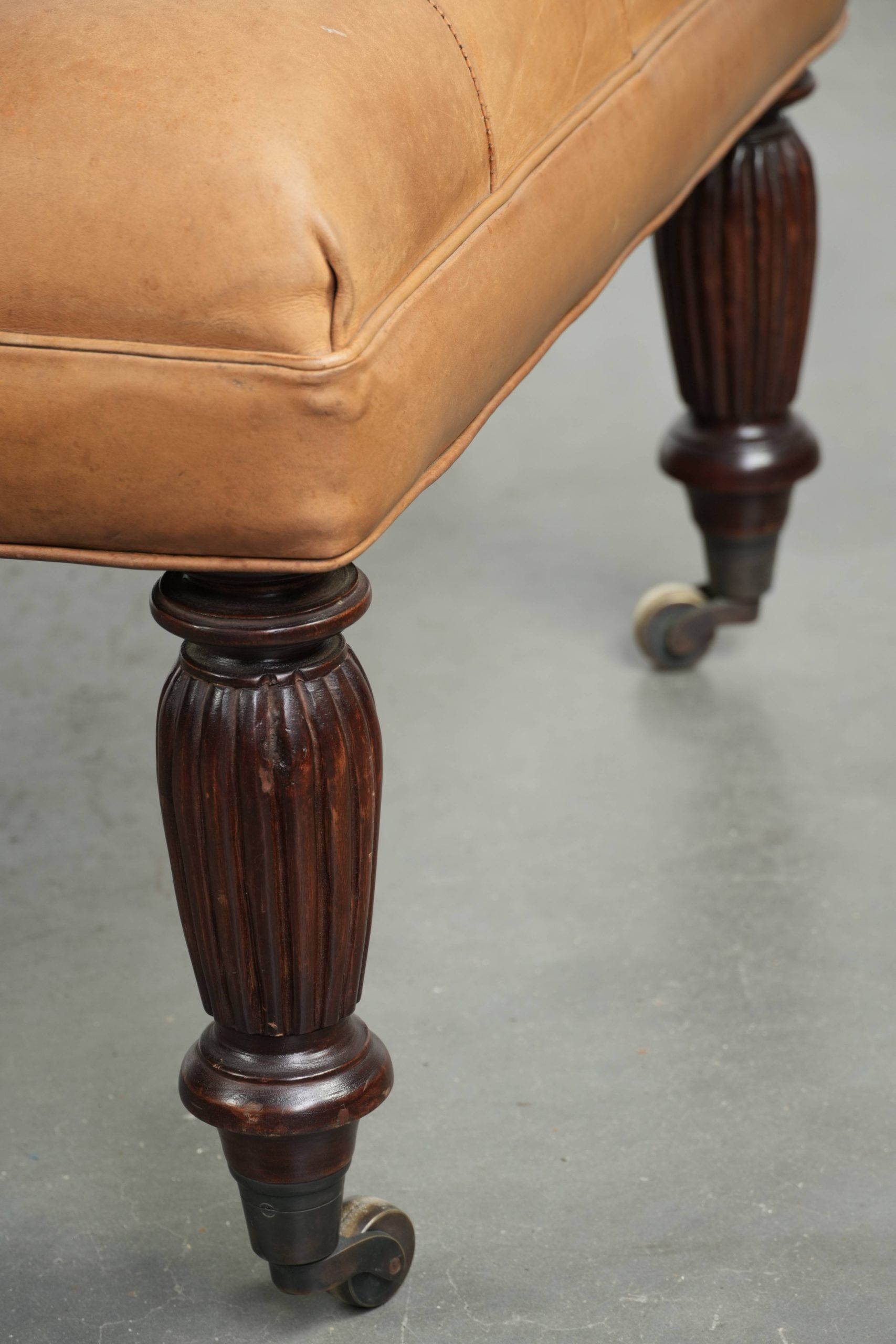 Sheepskin ottoman/coffee table on wheels in English chesterfield style