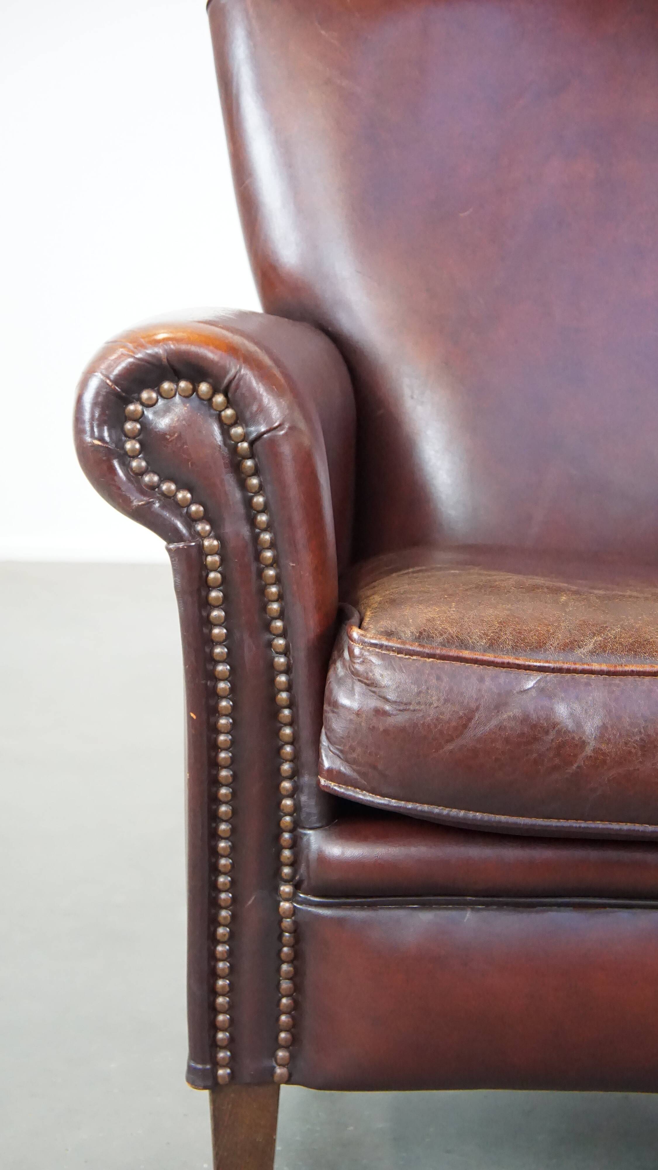 Sheep leather armchair correctly finished with decorative nails