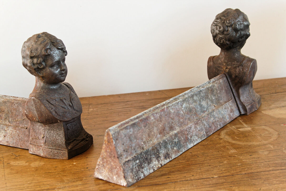 Pair of cast iron chenets, Love victorious